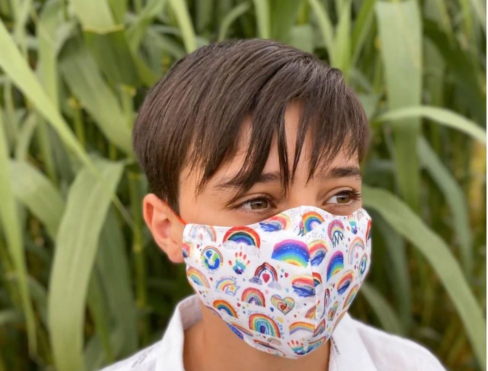 Image of a child wearing the MasksForAll rainbow mask